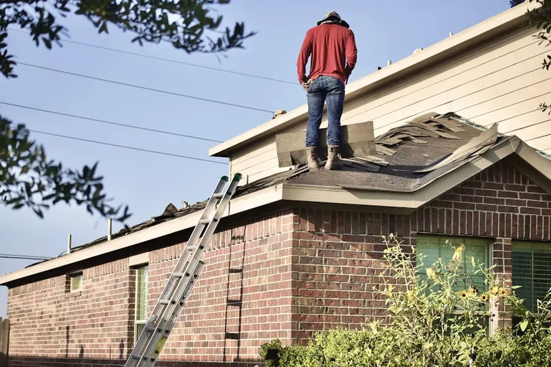 Professional roofer working on a residential roof in Grays River